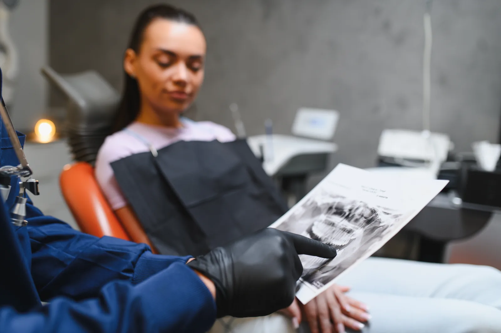 Dentist explaining a dental X-ray to a patient